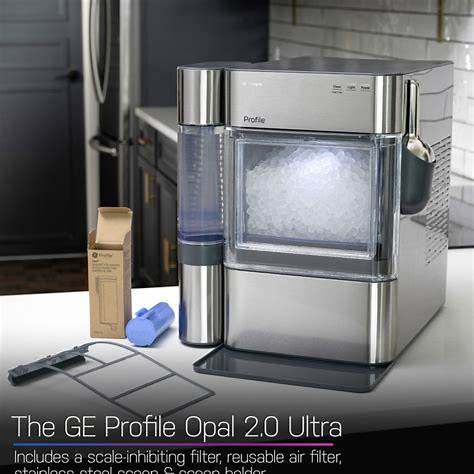 A GE Profile Opal 2.0 Ultra countertop ice maker with a clear panel showing ice inside, a scoop, and filters, placed on a kitchen countertop.